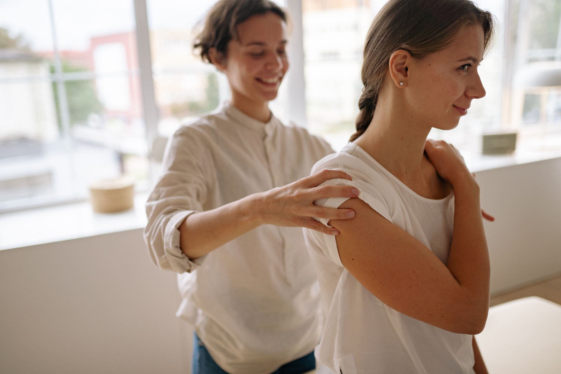 A massage therapist caring for a client