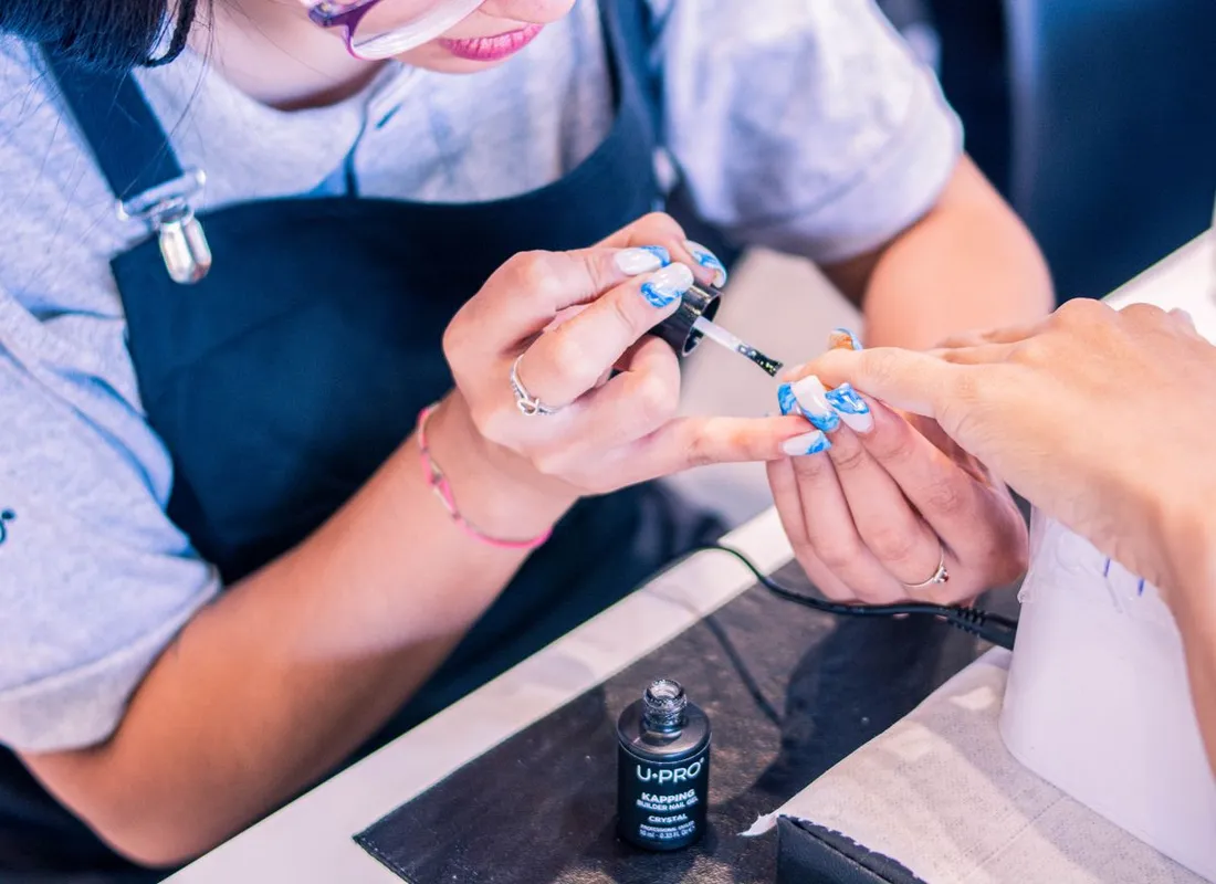 Nail technician giving a client a manicure