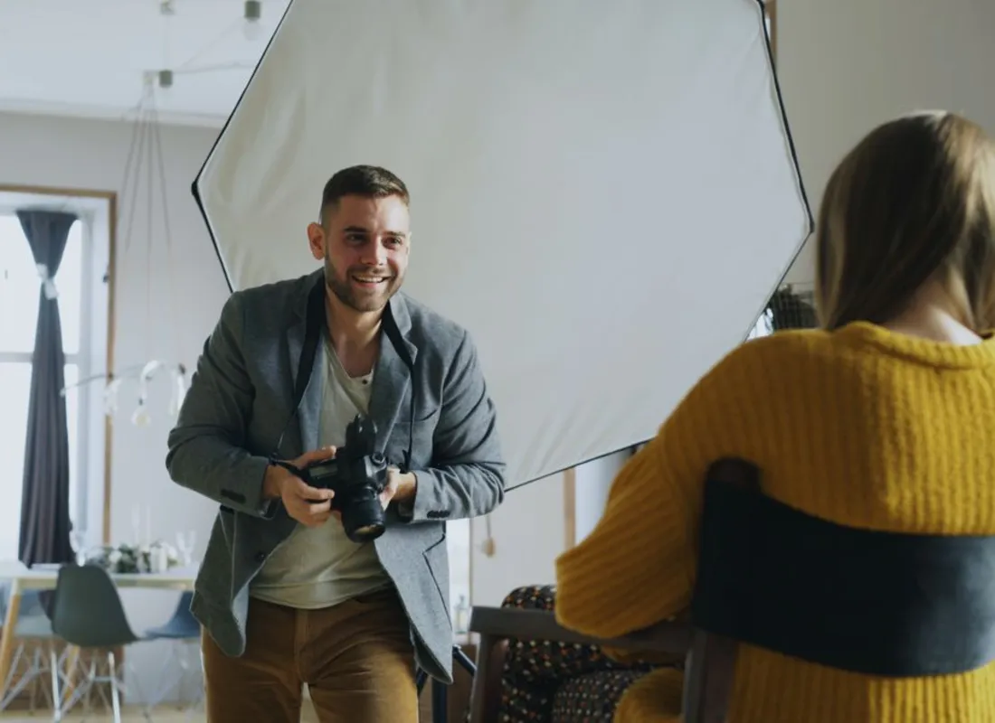 Photographer directing a portrait session in a studio
